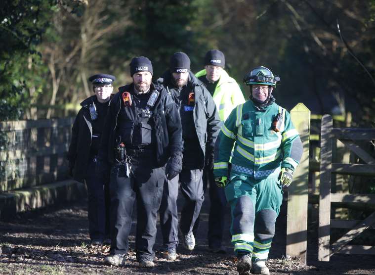 Officers and paramedics are searching the woodlands.