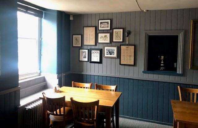 The separate bar at the front of the pub features a number of sporting photographs