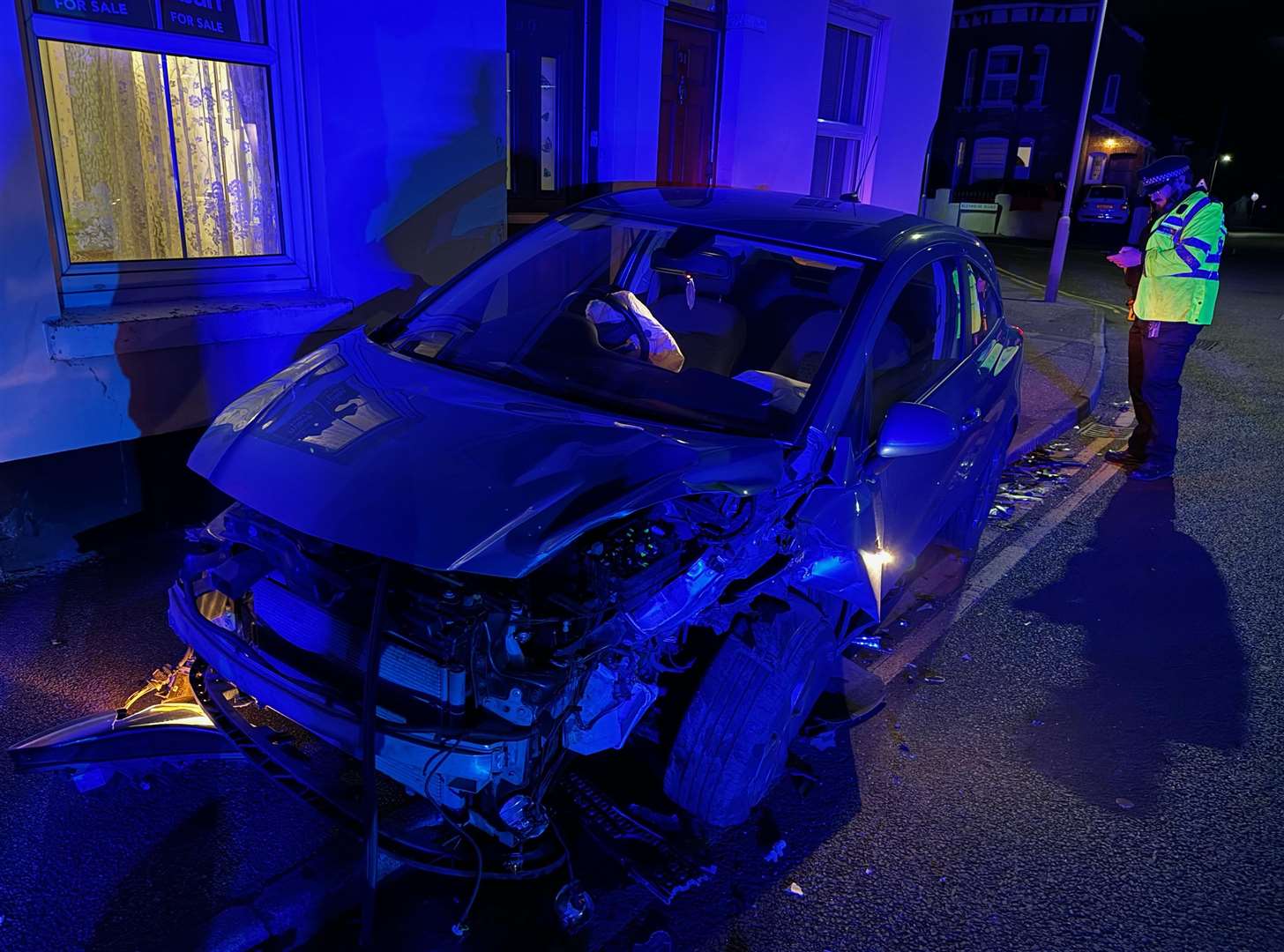 A police officer views Matthew Thorpe's damaged Vauxhall Corsa at Gilford Road, Deal