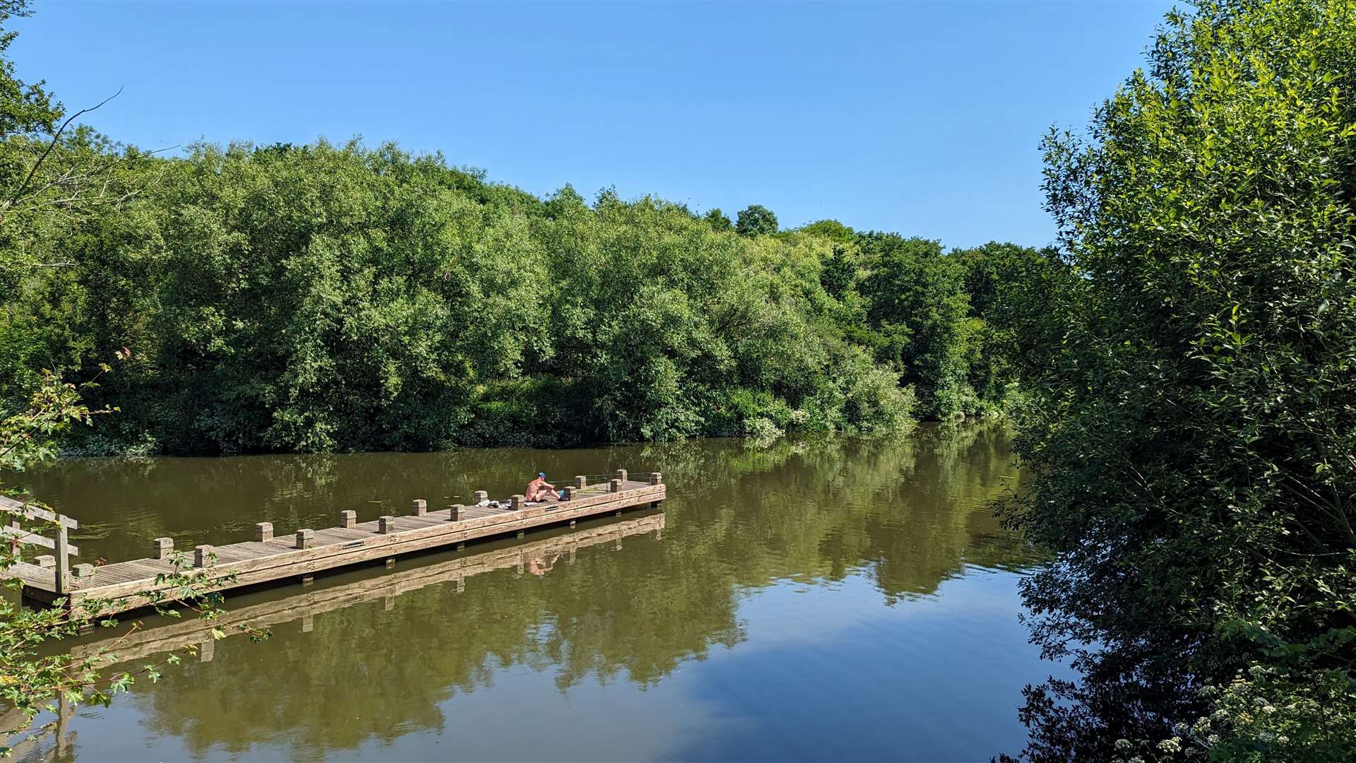 A lone fisherman on a jetty in the Medway