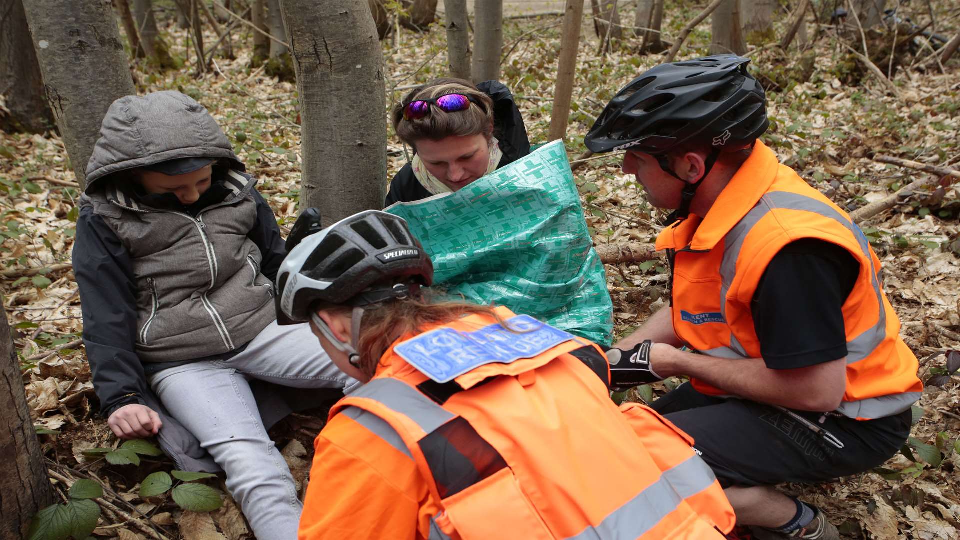 Volunteers give first aid the youngster found "injured" in the woods. Picture by Martin Apps.