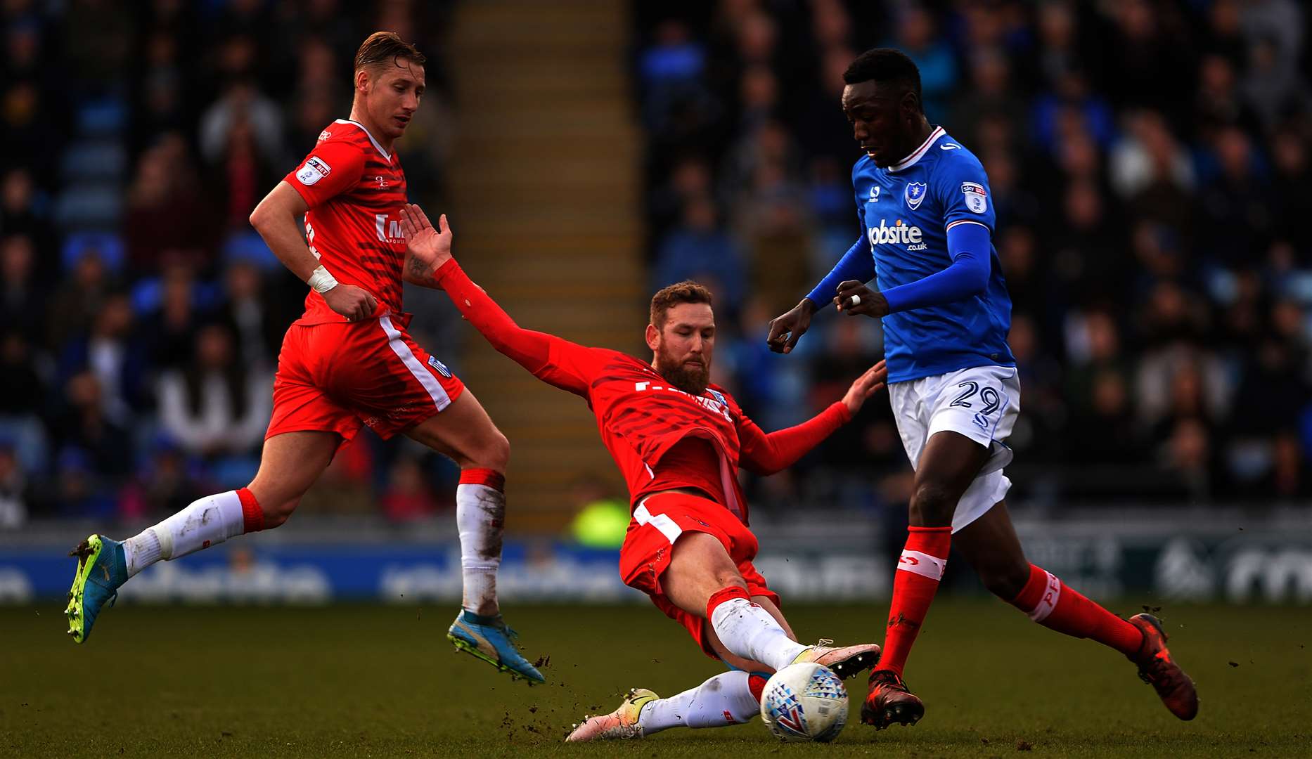 Gillingham's Scott wagstaff makes a challenge against Portsmouth's Sylvain Deslandes Picture: Ady Kerry