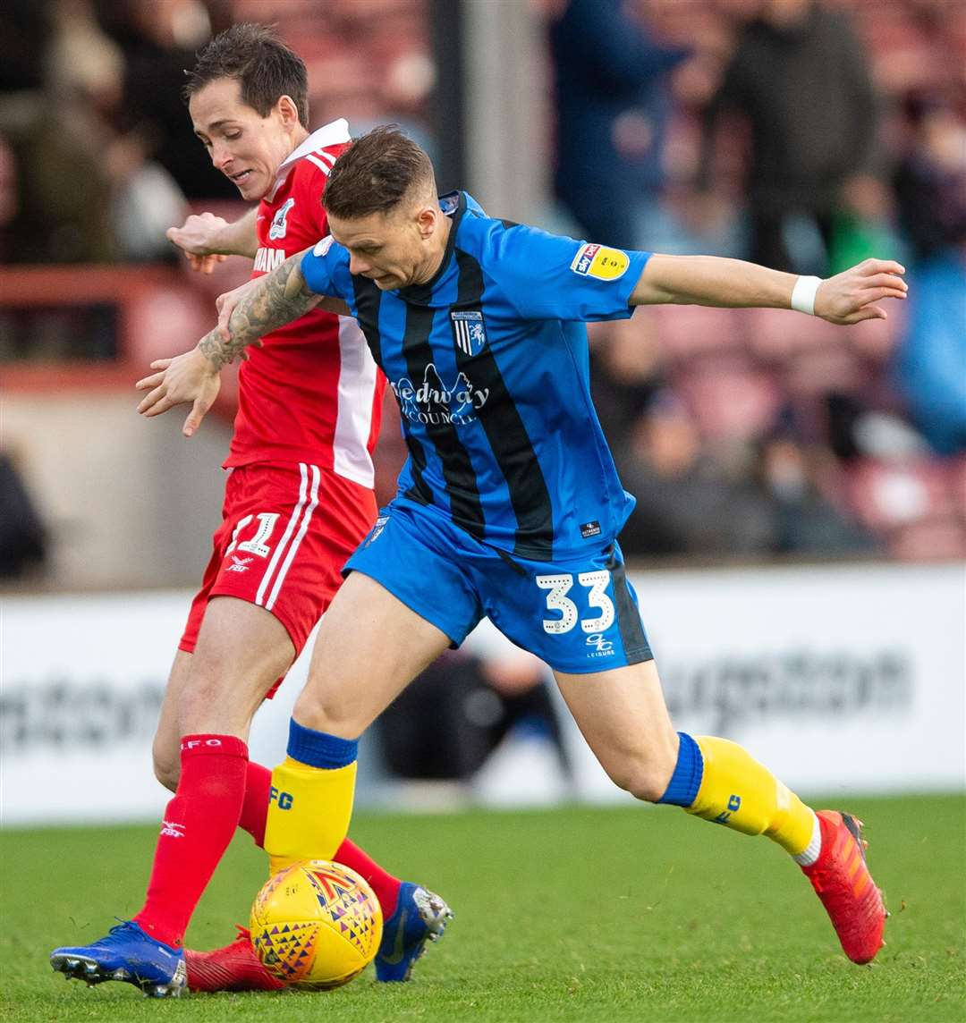 Josh Morris, left, battles Mark Byrne during Gillingham's game with Scunthorpe last season Picture: Ady Kerry