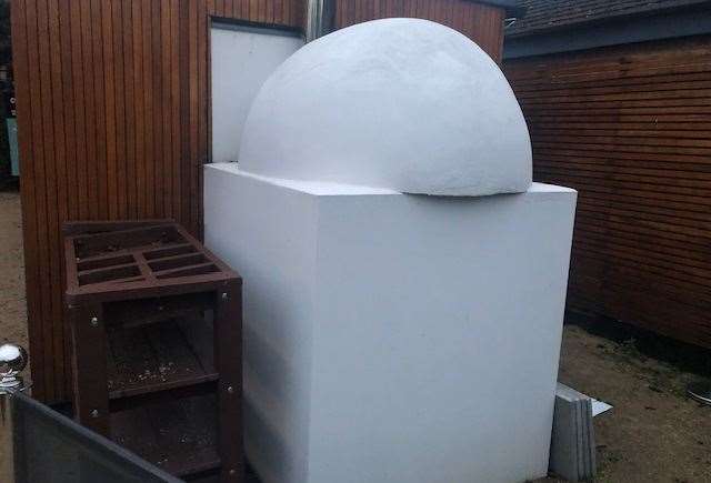 Looking a little like a modern art installation, I presume this is actually the back of an outdoor wood-fired pizza oven