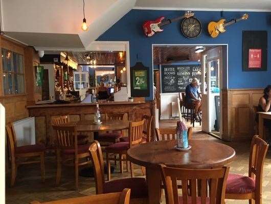 Turning left through the front door, you find yourself in a bar decorated by a whole host of music posters and at least half a dozen guitars