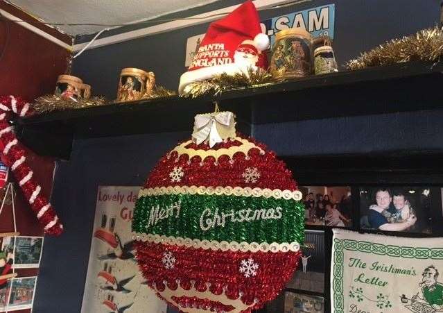 The Christmas decorations were up and the traditional tankards on the shelf are surrounded by gold tinsel