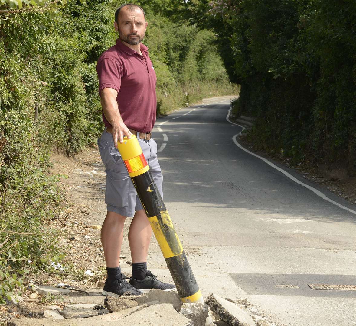 Mr Beba with a broken bollard. Picture: Paul Amos