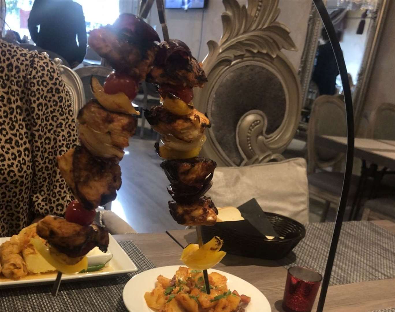 The skewers were hung above a plate of chips