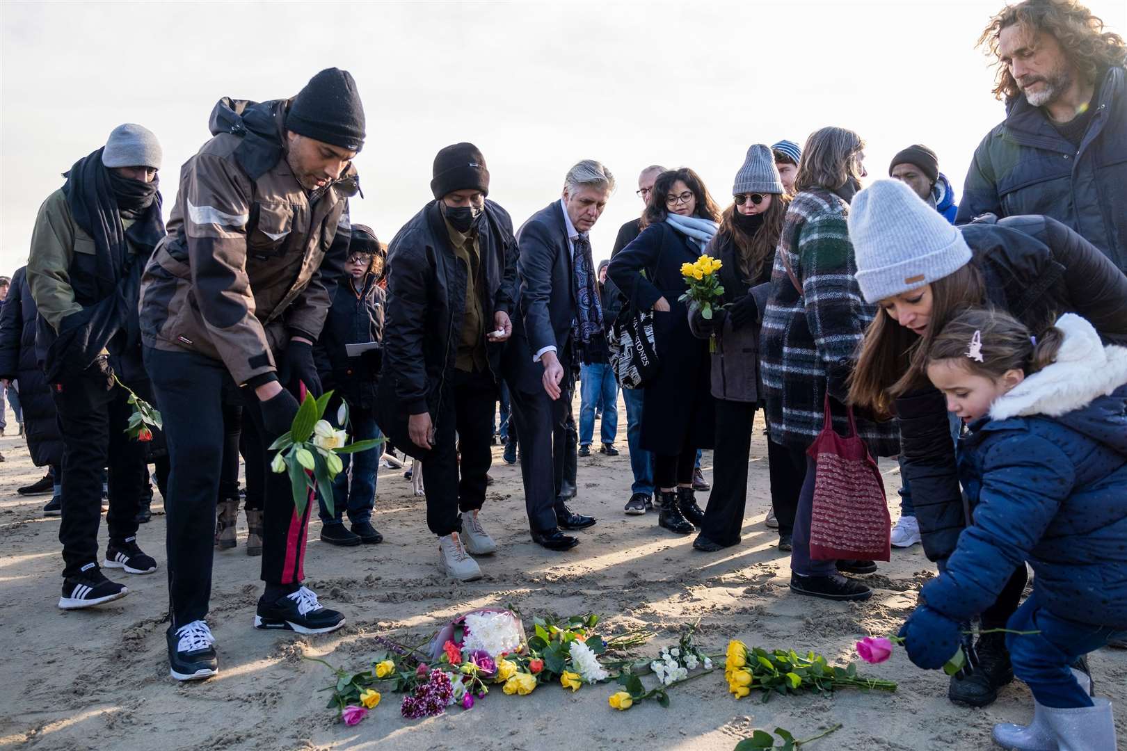 Local residents lay flowers on the sand on Sunny Sands Beach on 28th November 2021 in Folkestone. Photo by Andy Aitchison