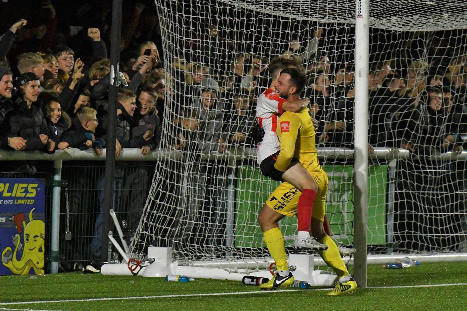 Sheppey keeper Aiden Prall picks up penalty shootout matchwinner Jacob Lambert Picture: Marc Richards