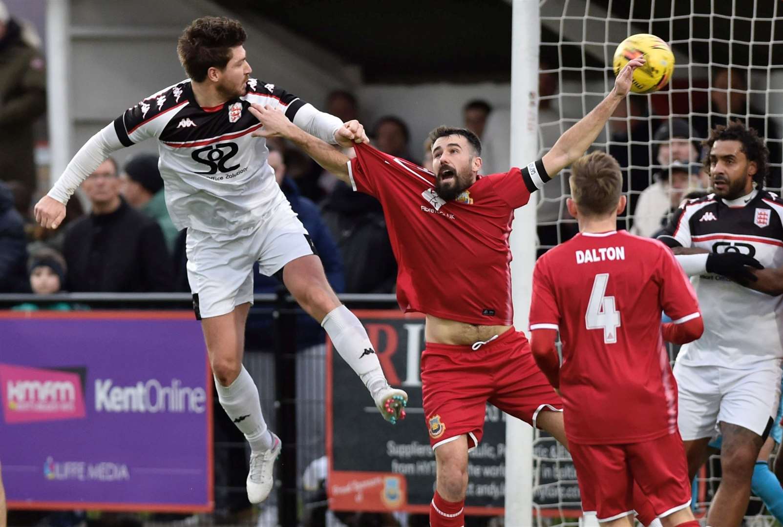 Faversham’s Matt Newman holds off Whitstable skipper Tom Mills to head home their second goal during their 2-2 draw on Saturday. Picture: Ian Scammell