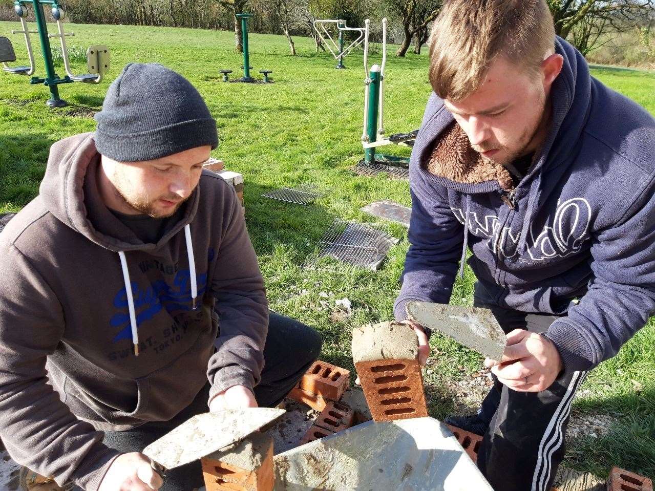 Members also play active roles in the community, as they are seen here building a community barbecue