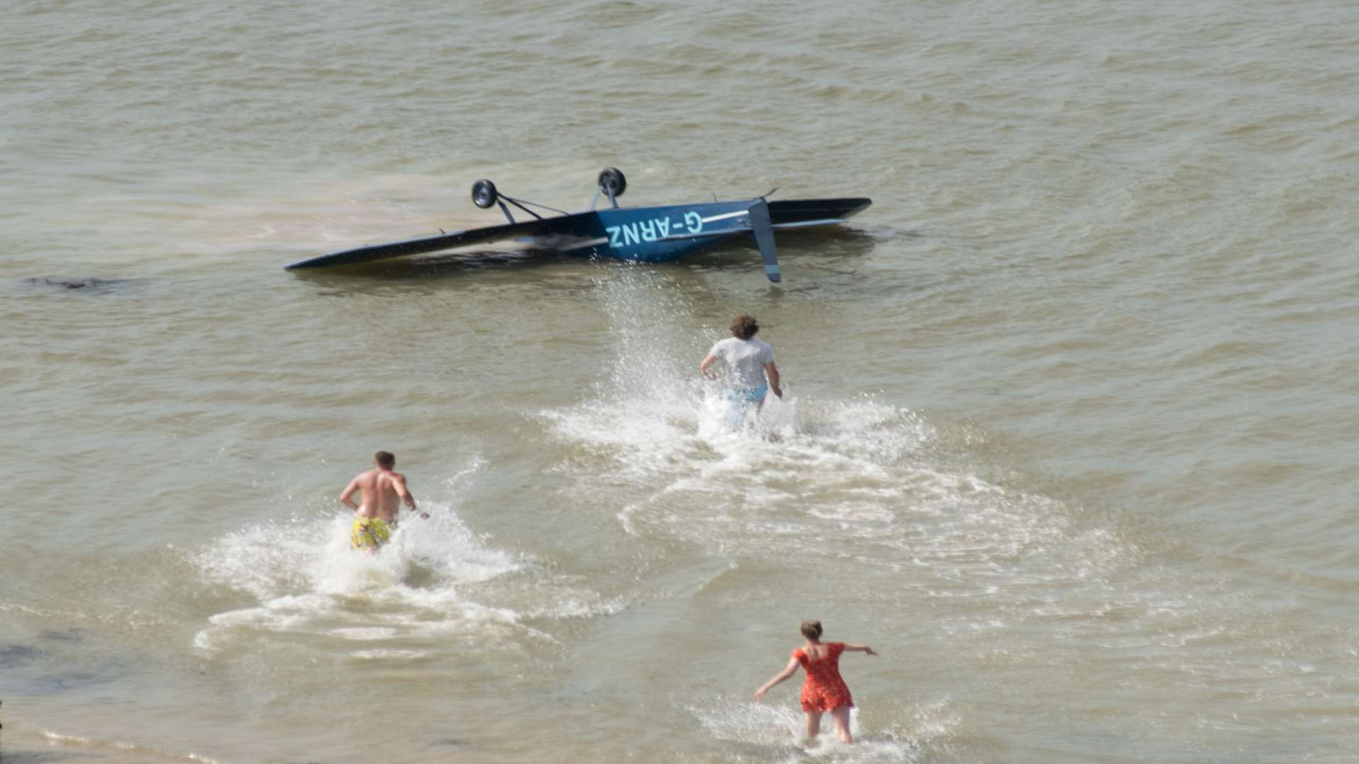 Onlookers rush to the pilot's aid. Picture: Nigel Hancock