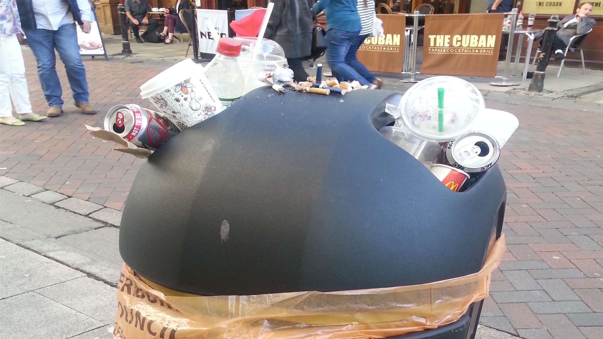 A bin full to bursting in the High Street