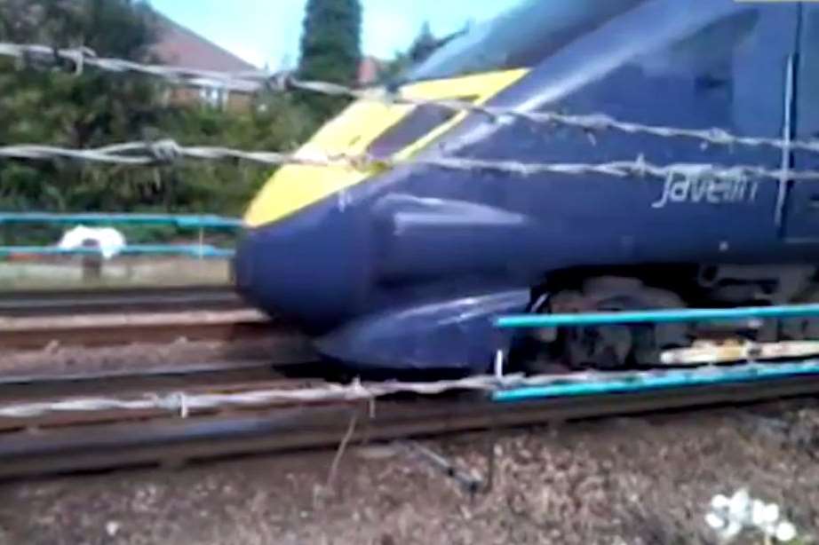 A train passes along the fence filmed by Susan Dray