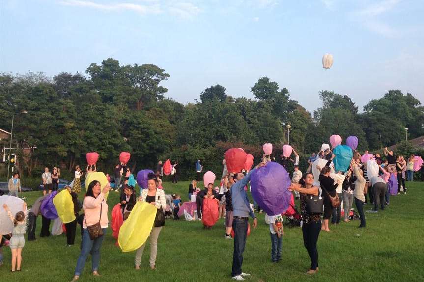 Jade's friends and family release paper fire lanterns