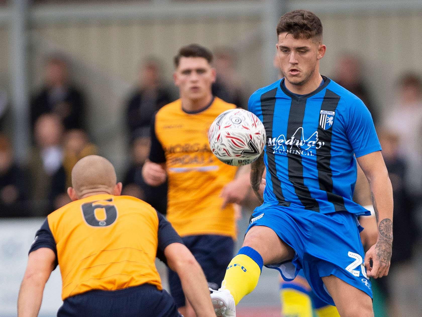 Darren Oldaker dinks the ball over Lee Togwell Picture: Ady Kerry