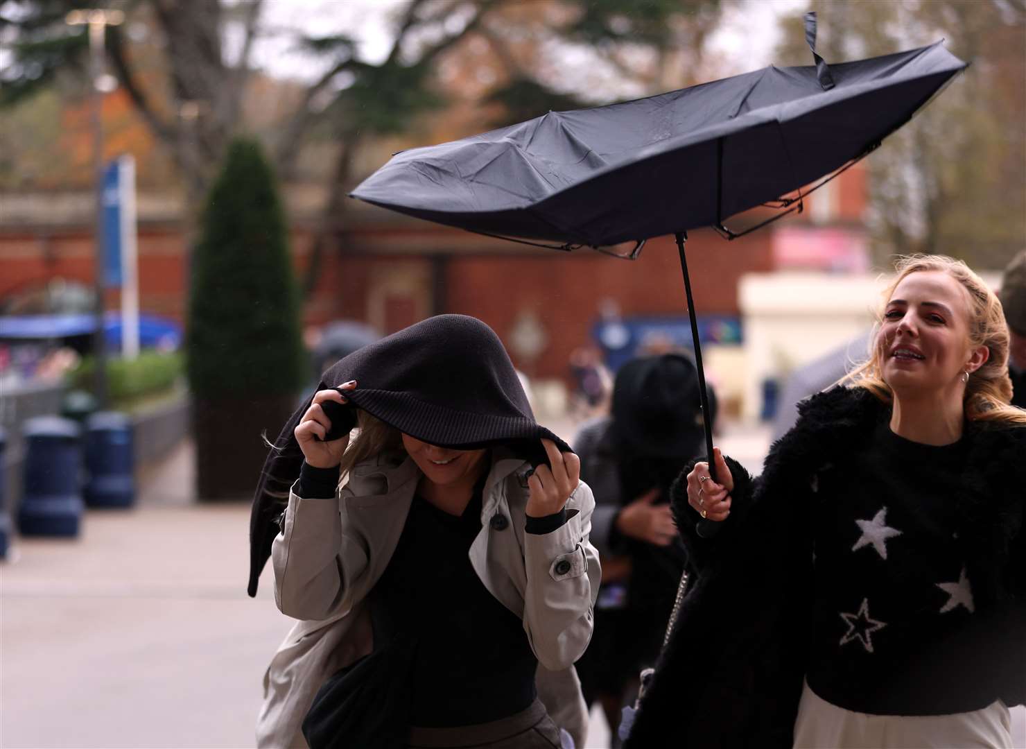 Racegoers battle the wind and rain at Ascot Racecourse on Saturday (Steve Paston/PA)