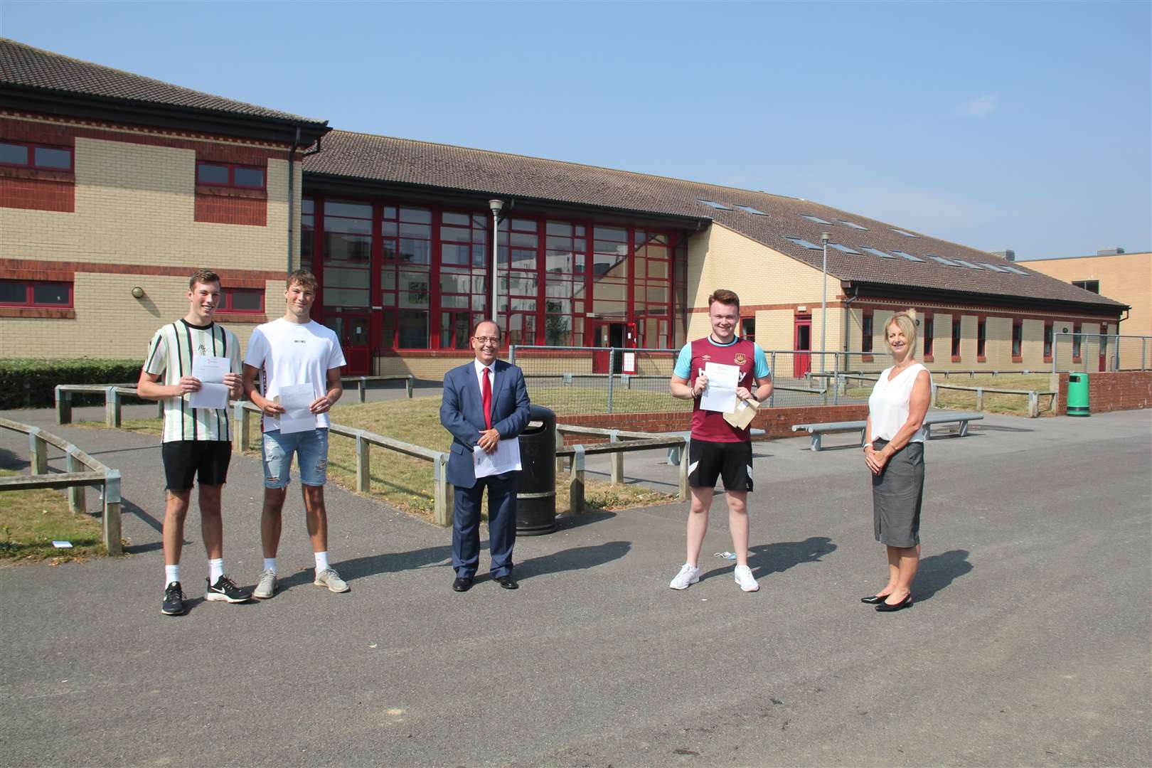 Twins Blake and Toby Woods celebrate their successful A Level results alongside Jack Ryan - who's studying football management - with principal John McParland and assistant principal Mrs Elizabeth McParland