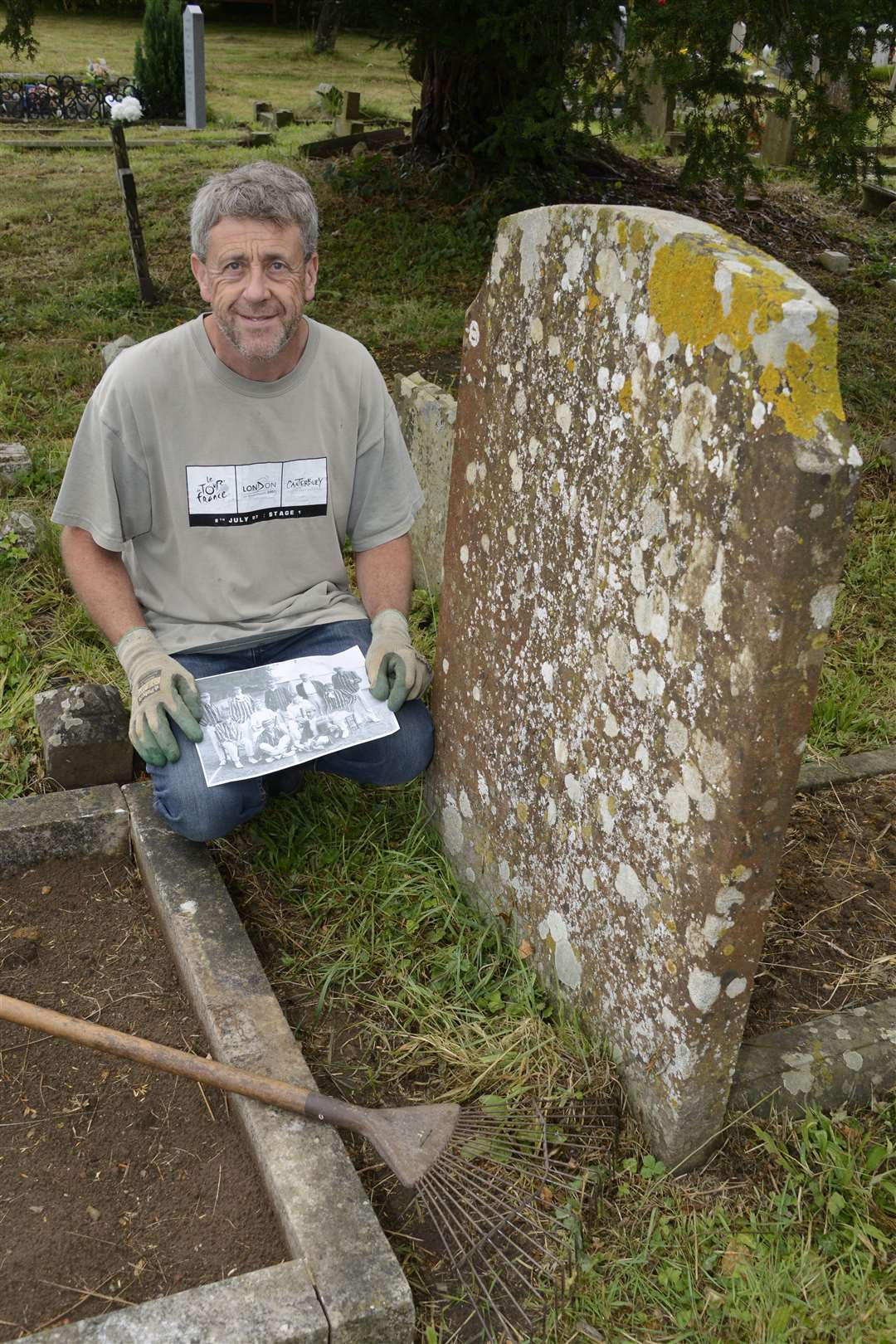 Chris Rogers at the grave with an old cricket team photo showing Cecil Headlam