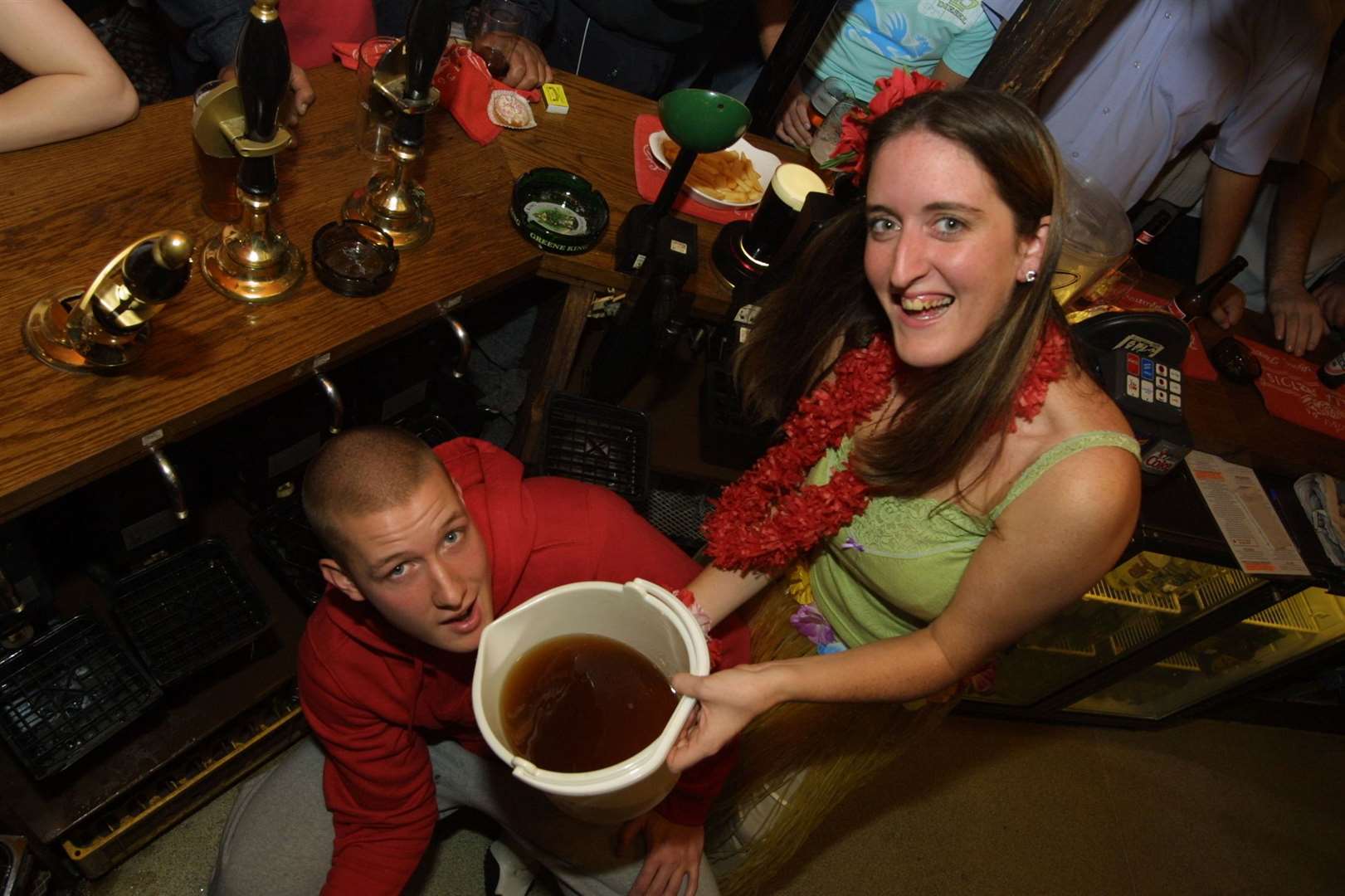 Gary Blake, barman at the Five Pointed Star pub in West Malling, downs 8.5 pints for Children in Need aided by organiser Corinna Simpson in November 2002 . The pub is still open today