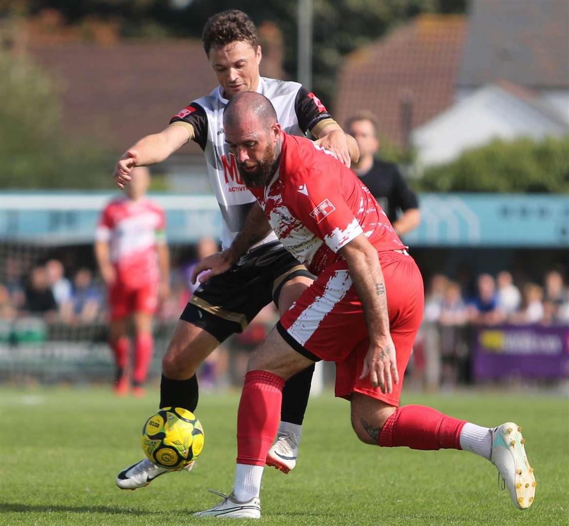 Deal's Rory Smith up against Ramsgate defender Joe Ellul as the Rams ran out 4-2 winners on Bank Holiday Monday in front of a massive crowd of 1,895. Picture: Paul Willmott