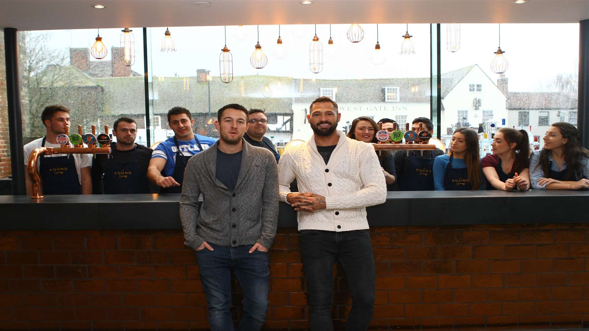 Business owners Steve Allen and James Caldon with members of their staff at One Pound Lane, in Canterbury