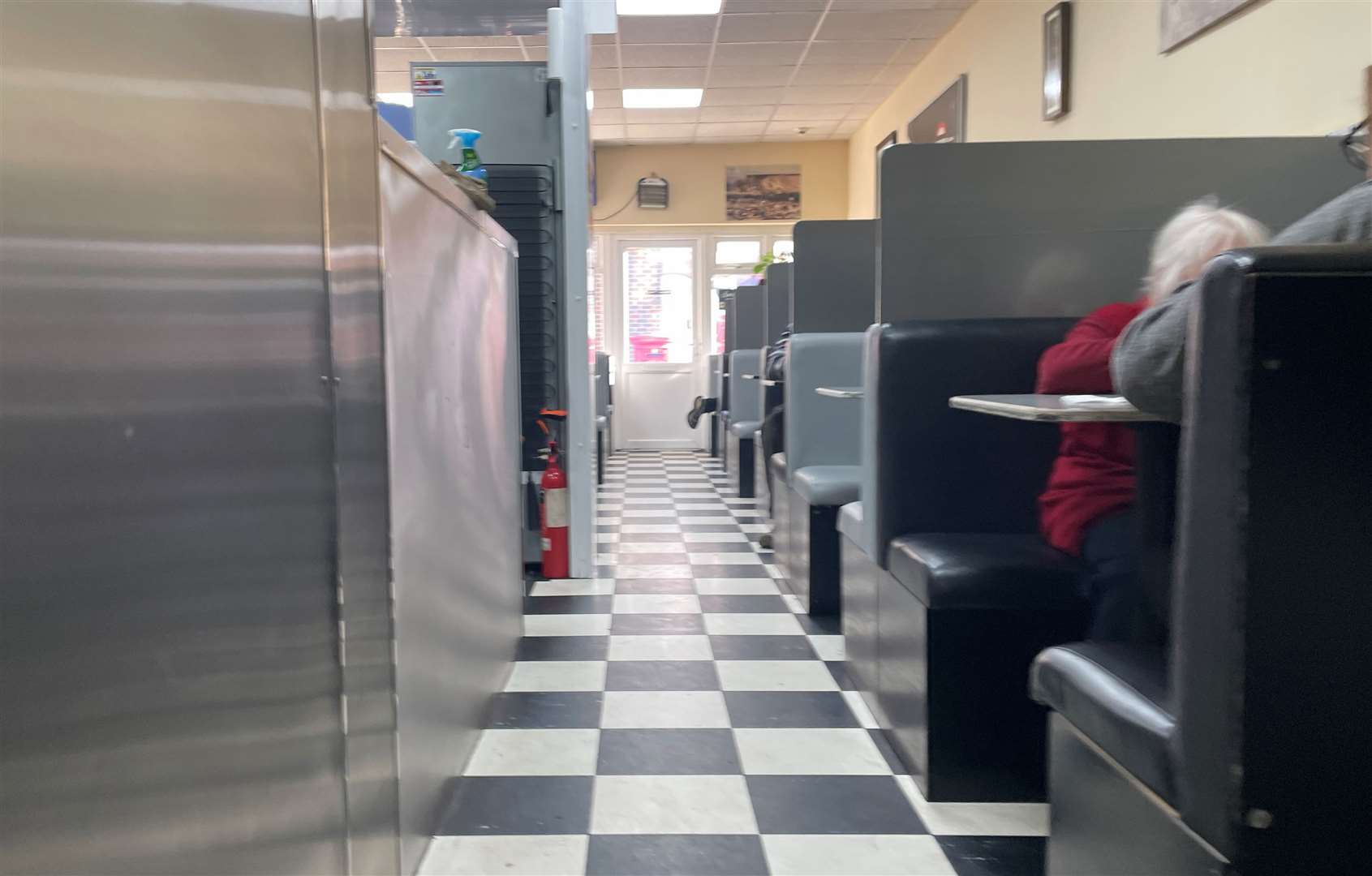 The black and white flooring and booths at the cafe