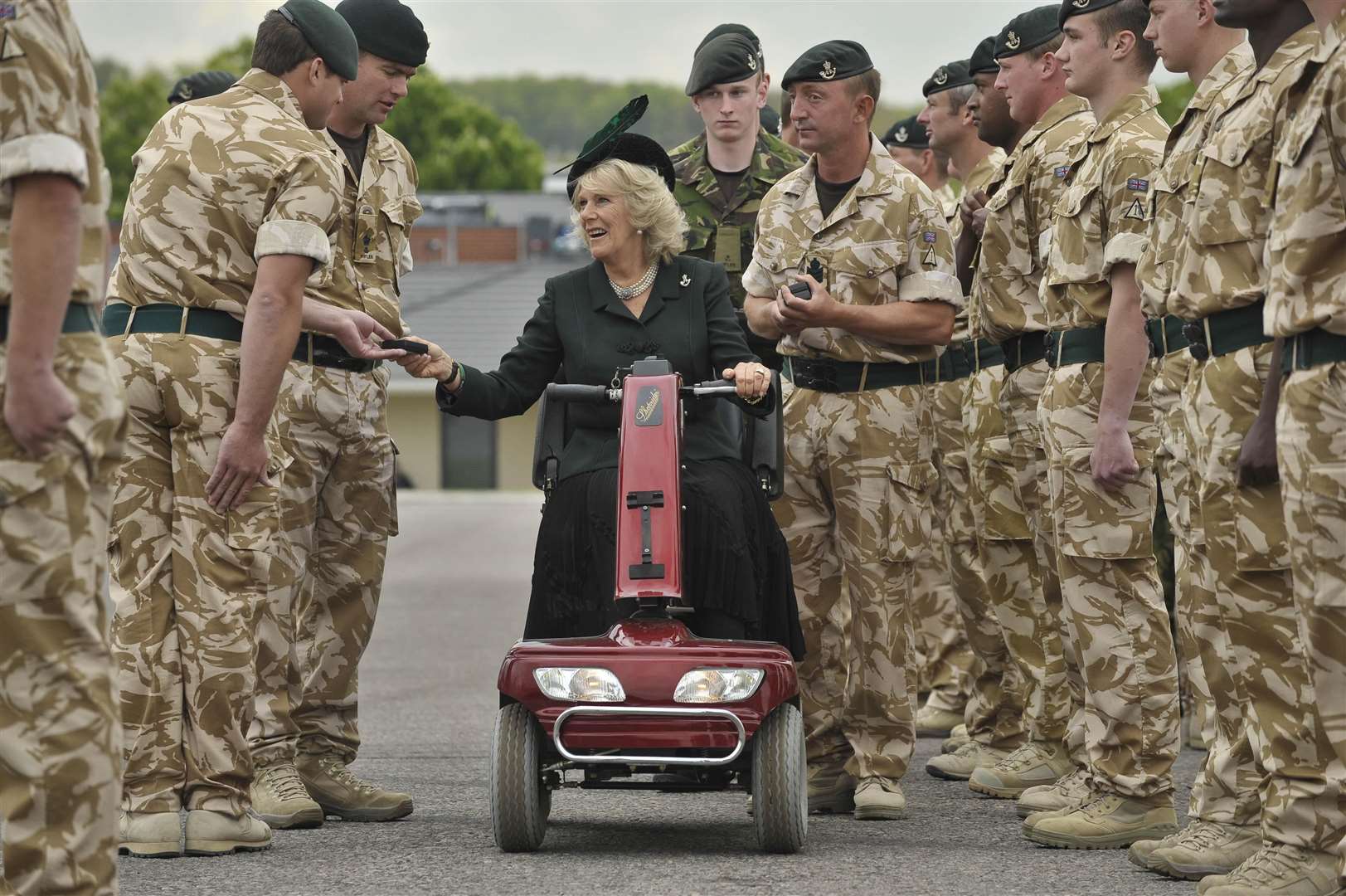 Camilla rode on a red mobility scooter as she presented medals to soldiers of 4th Battalion The Rifles at Bulford Camp, Wiltshire, in 2010 (Ben Birchall/PA)