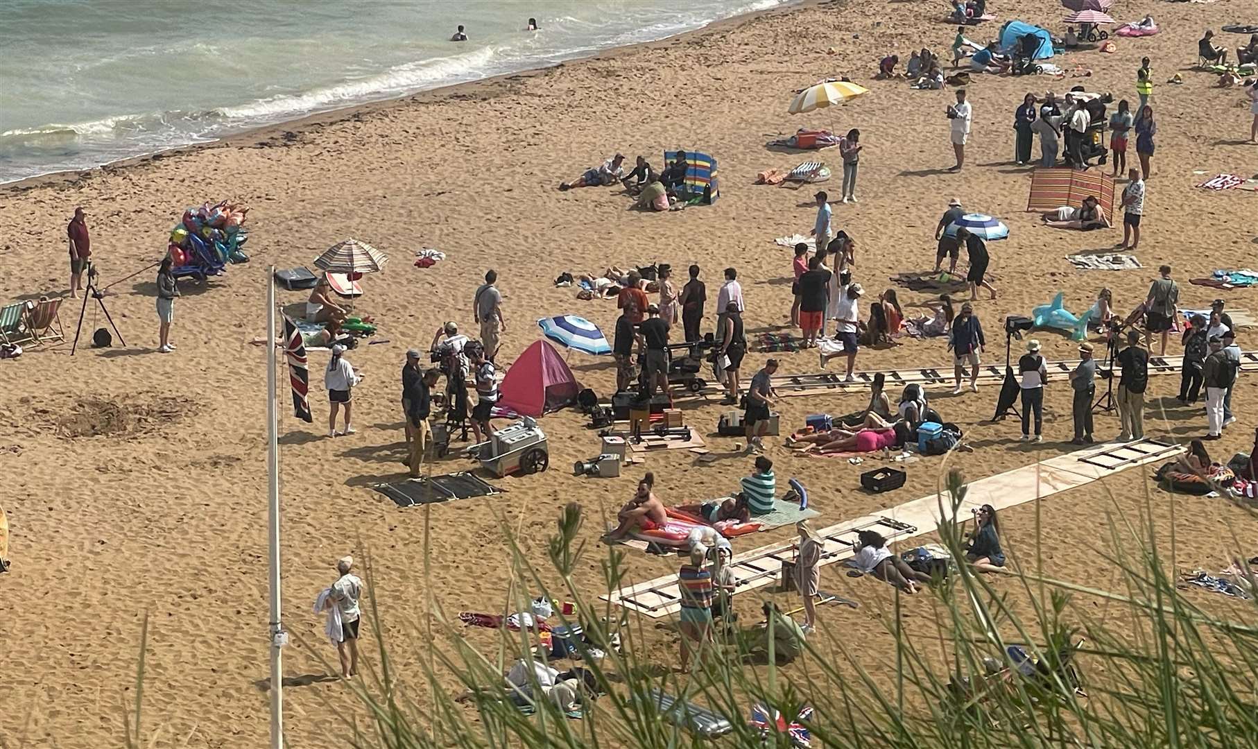 She was seen walking along the beach in May filming the piece