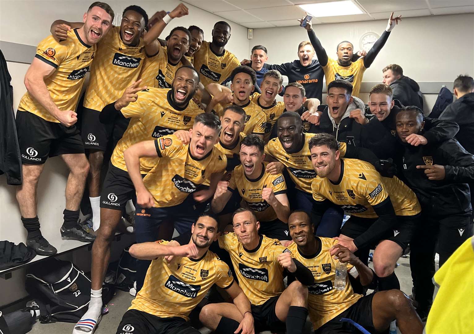 Maidstone United players celebrate in the dressing room after beating Stevenage. Picture: Steve Terrell