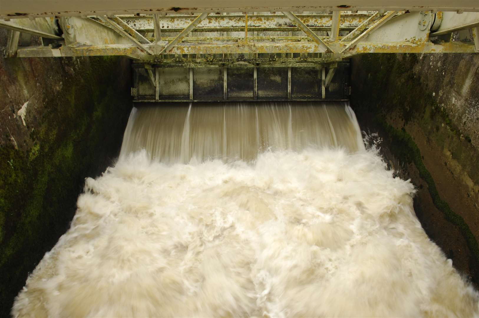 River water rushes through the weir in Yalding