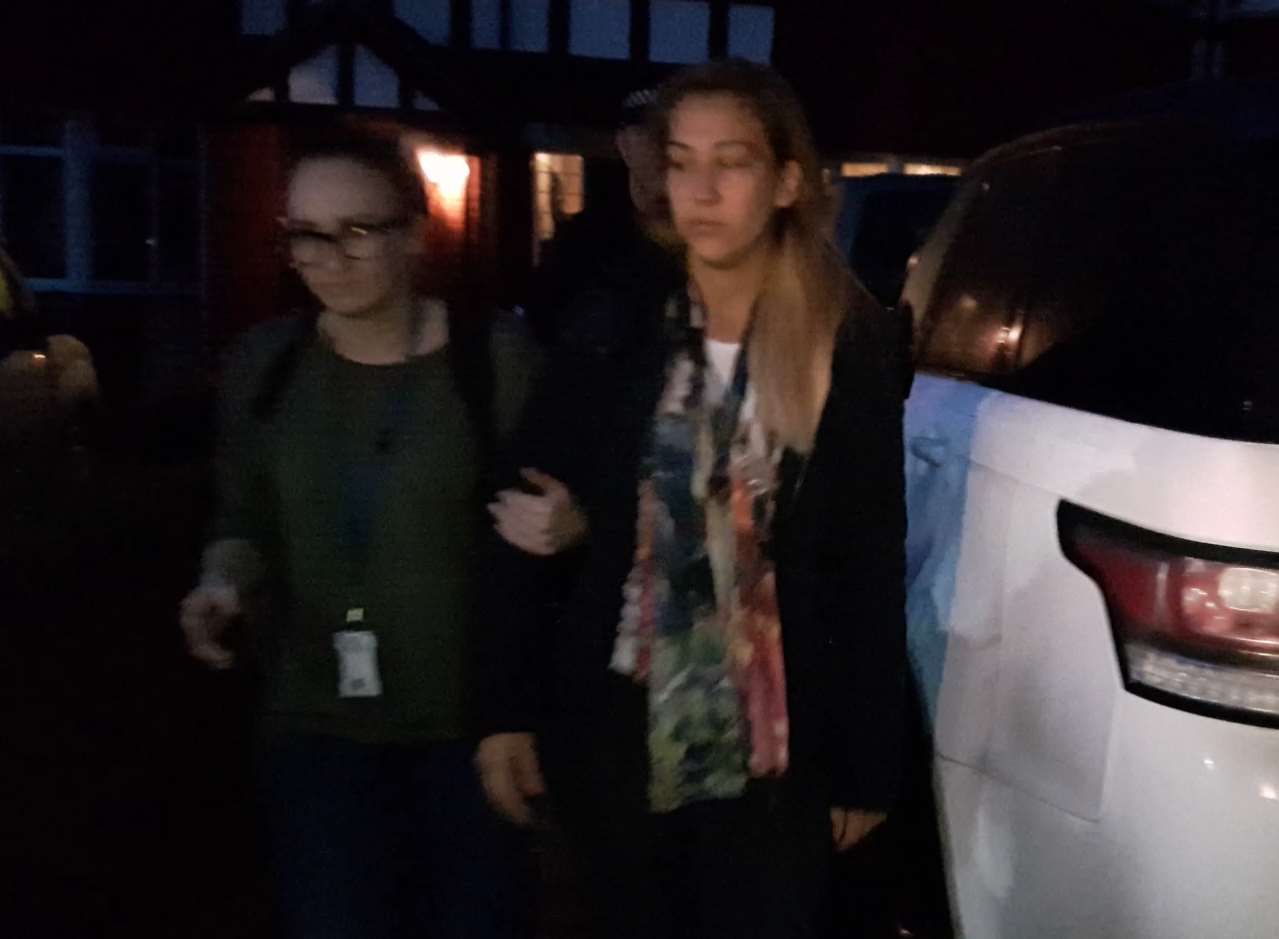 A woman is led away by police after the raid in Harcourt Drive