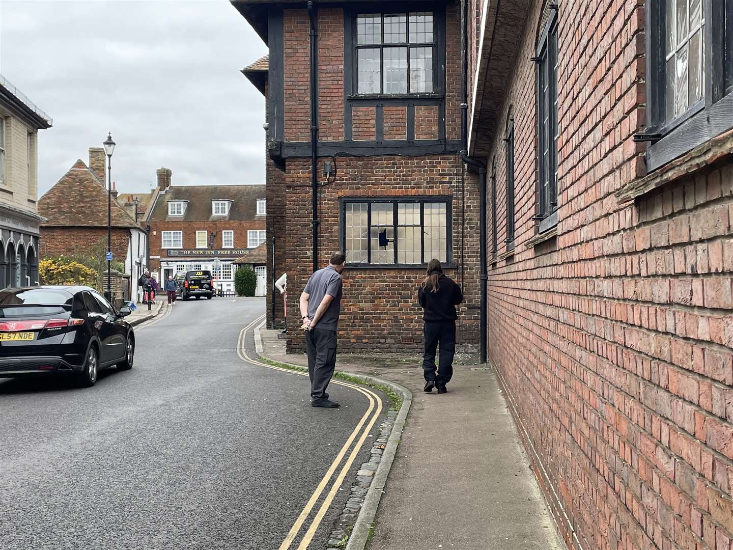 A police officer is seen photographing a smashed window on the Cattle Market side of the Grade II* listed building