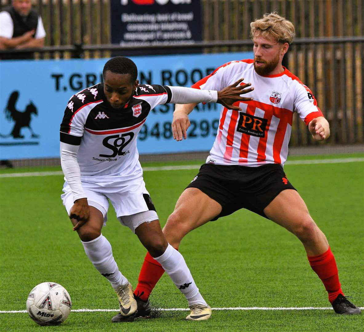 Kieron Campbell, of Faversham, tries to turn away from Sheppey's James Taylor. Picture: Marc Richards