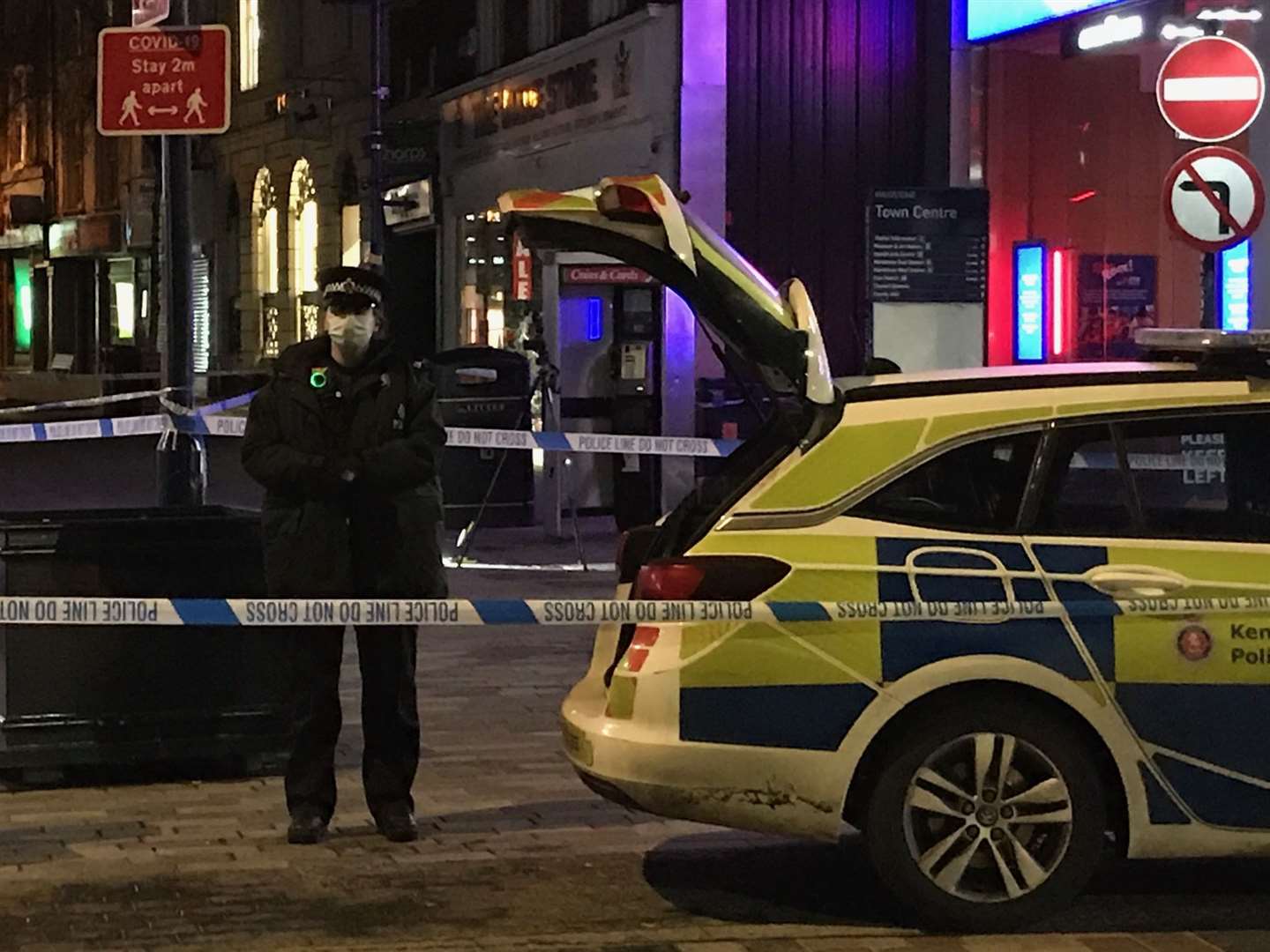 A police officer stands guard at a cordon at the High Street end of Week Street