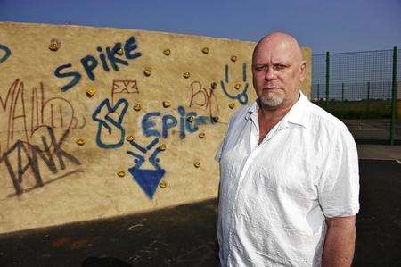 Cllr Mick Constable inspects the graffiti at the Whiteways Road play