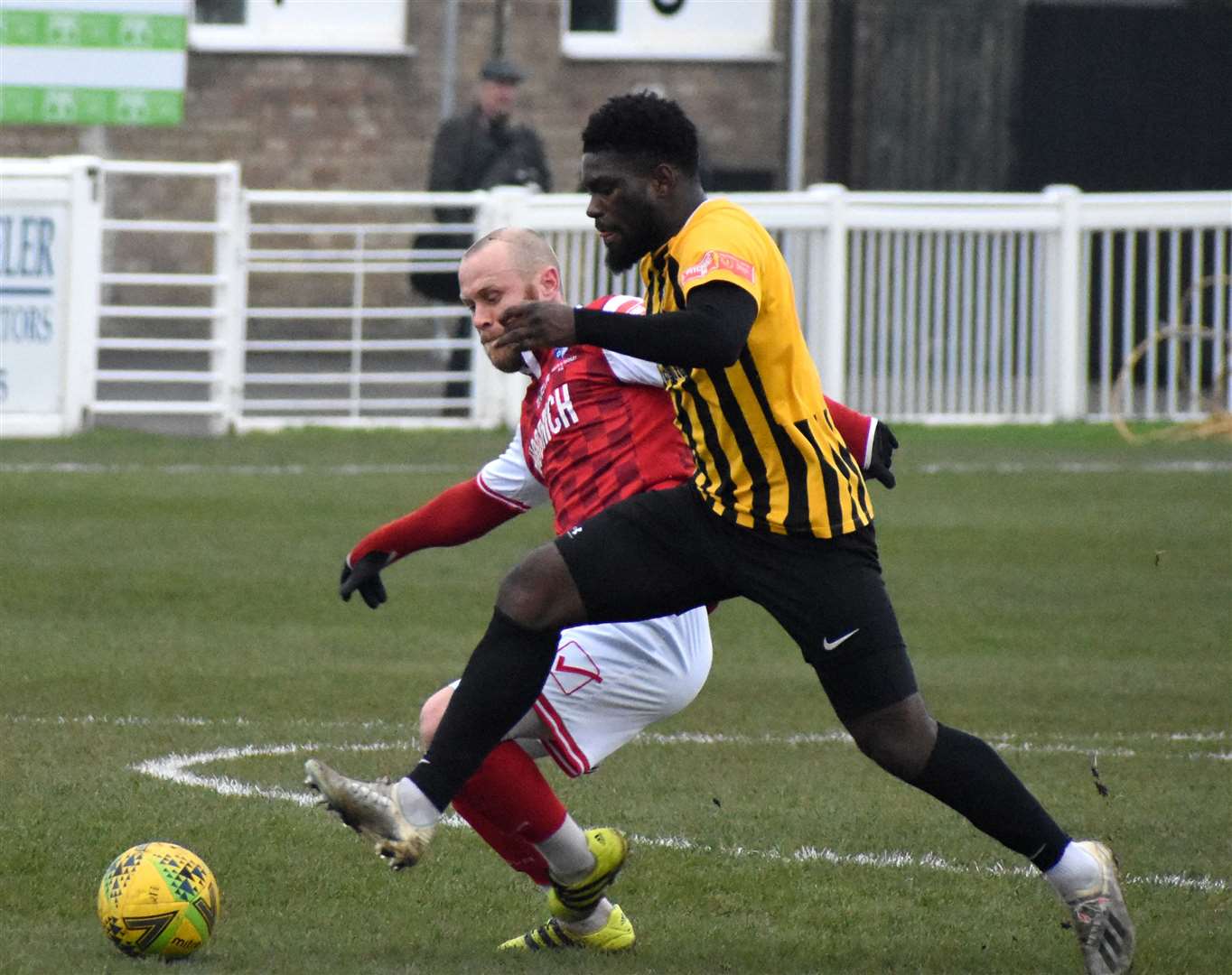 Folkestone Invicta's Dave Smith tussles with a Wingate & Finchley player