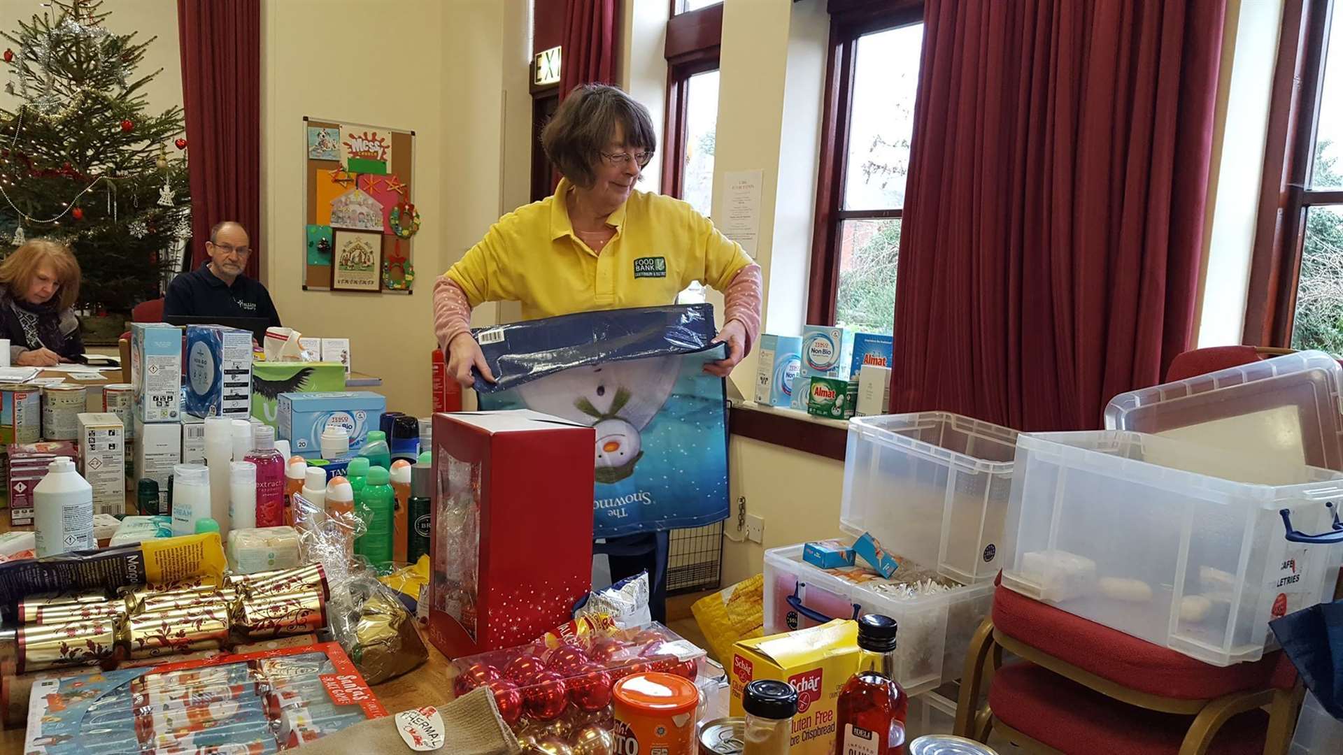 Volunteers hand out extra items from the "bonus table"