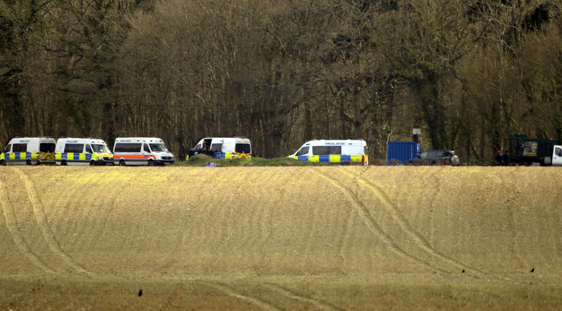 Eight police vans were spotted in Fridd Lane this morning alongside a shipping container-like structure and rubbish clearance van. Picture: Barry Goodwin