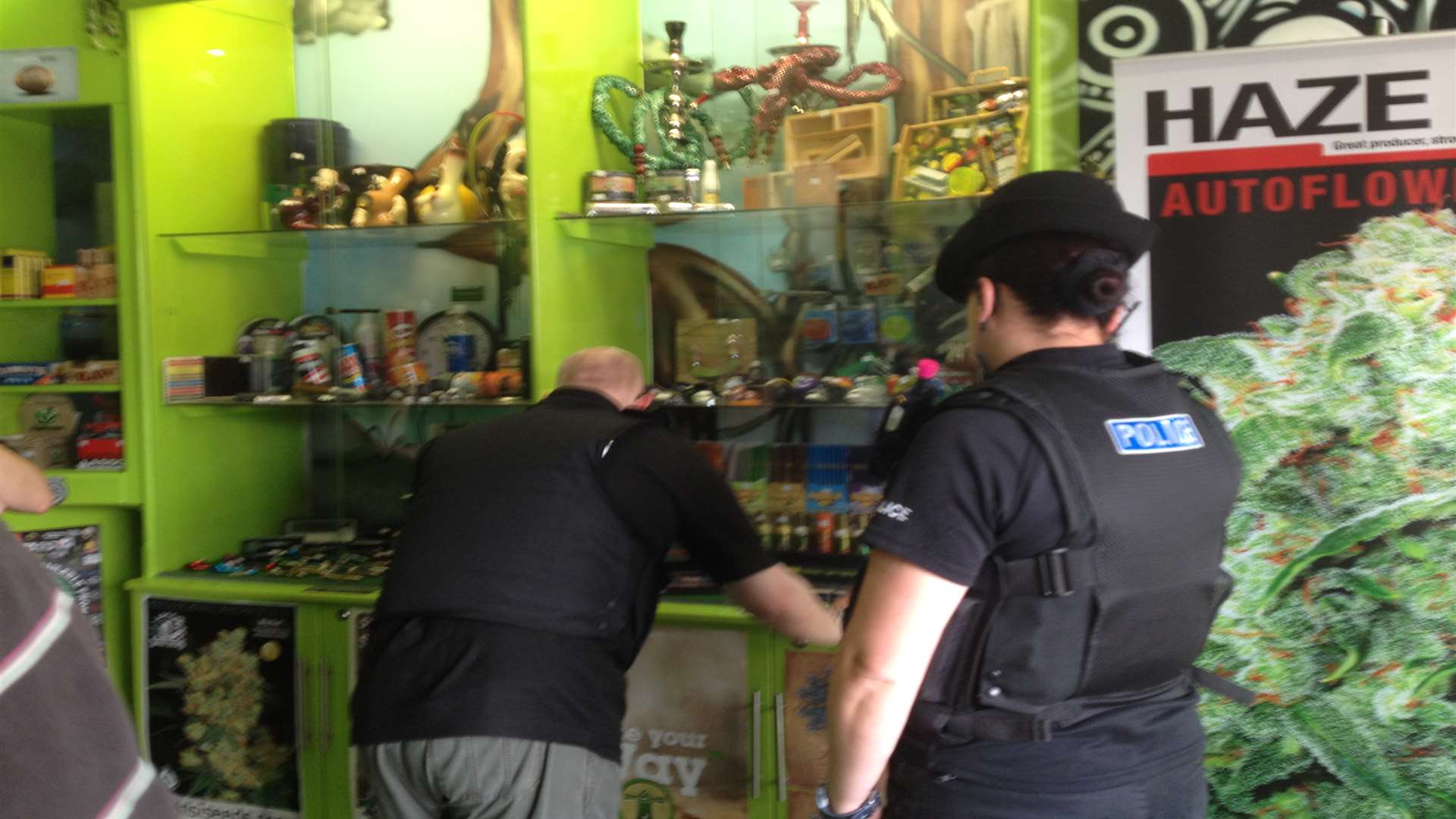 A Trading Standards officer examines a cabinet displaying incense