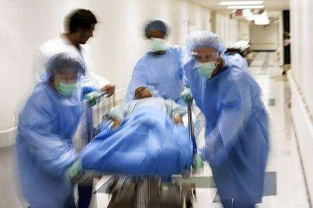 A patient being rushed through a hospital ward