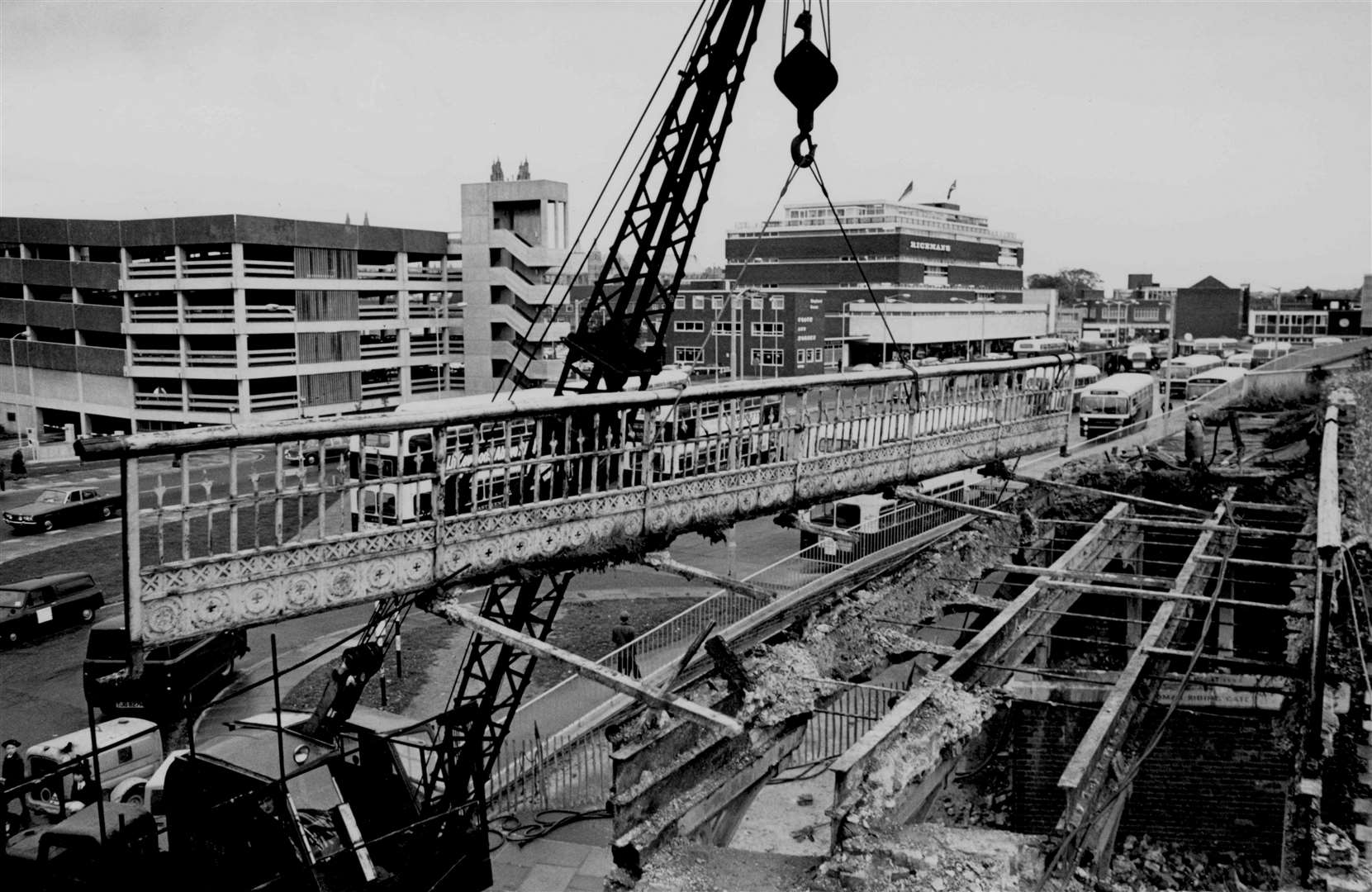 The mid-Victorian Riding Gate bridge in Canterbury is lifted away by a crane in October 1970 to make way for a new pedestrian walk along the city walls. The bridge ended up in Heathfield Wildlife Park, Sussex