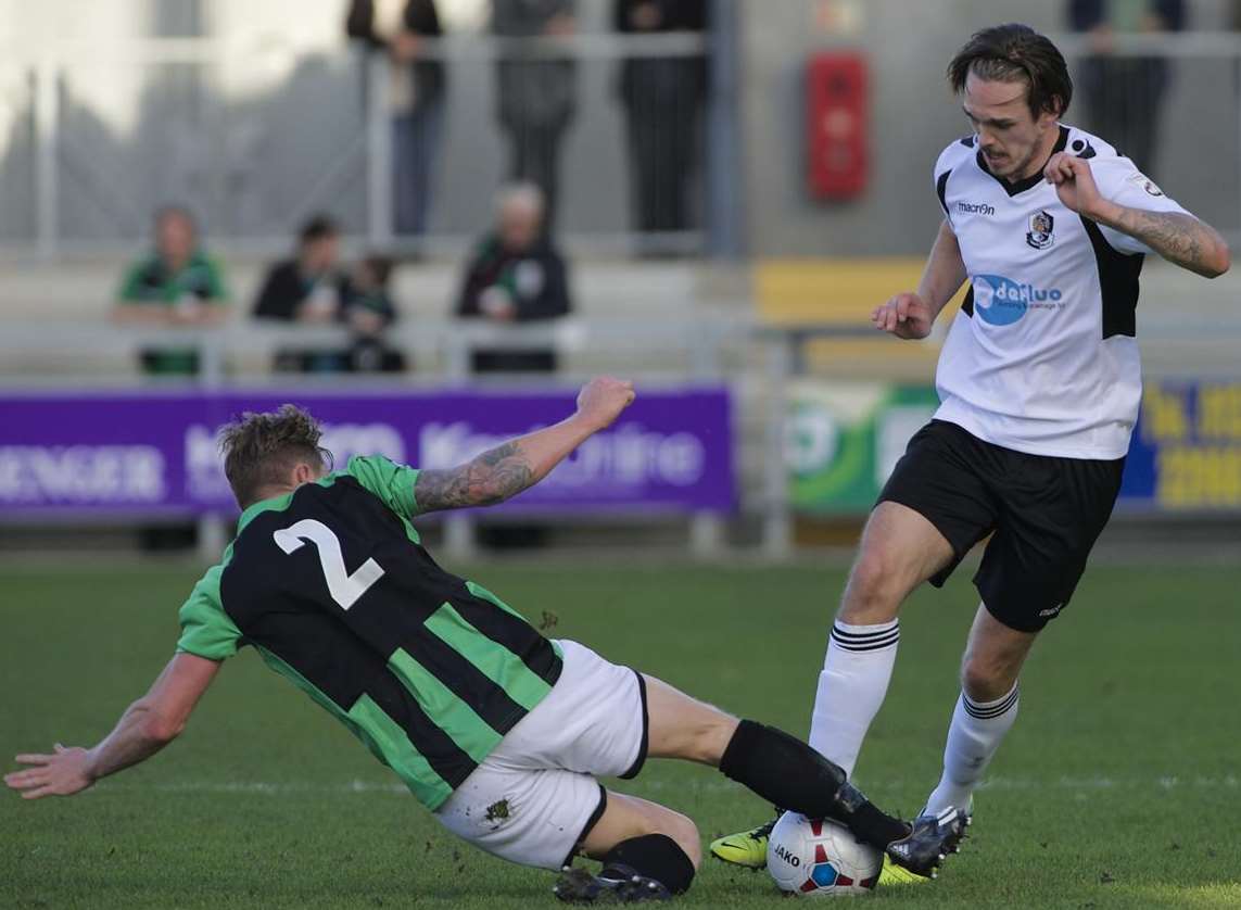 Tom Bender takes on Burgess Hill's Neil Watts during Saturday's FA Cup clash Picture: Andy Payton FM3477678