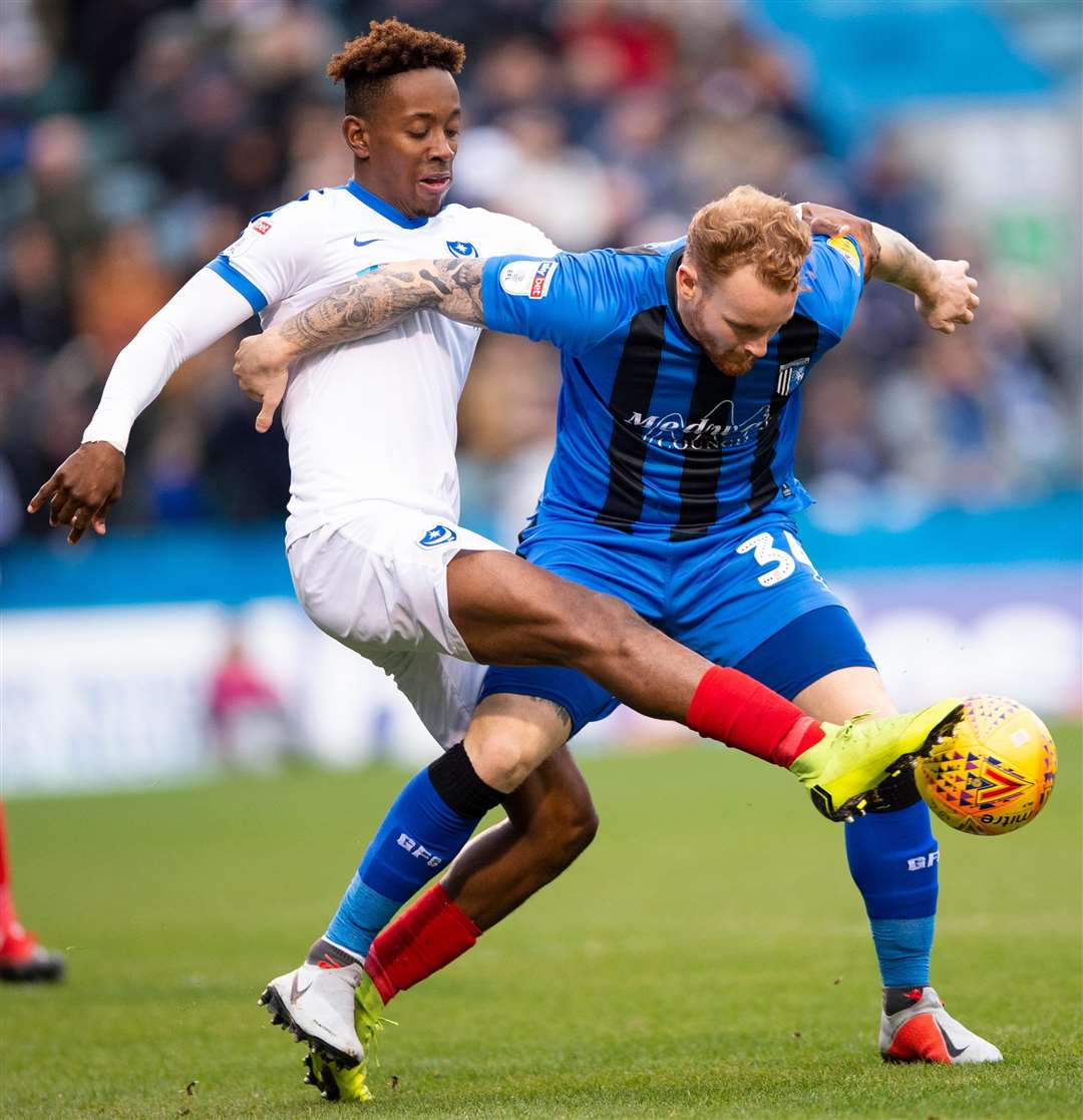 Gillingham's Connor Ogilvie holds off Jamal Lowe. Picture: Ady Kerry