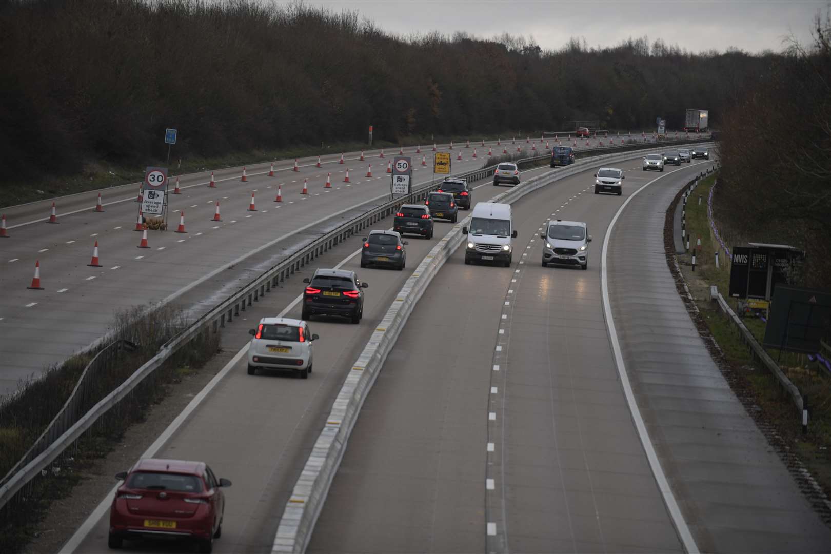 The moveable barrier separates drivers heading in opposing directions. Stock photo