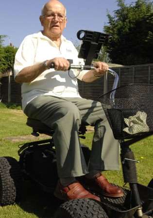 Basil Brazier on his ride-on golf buggy