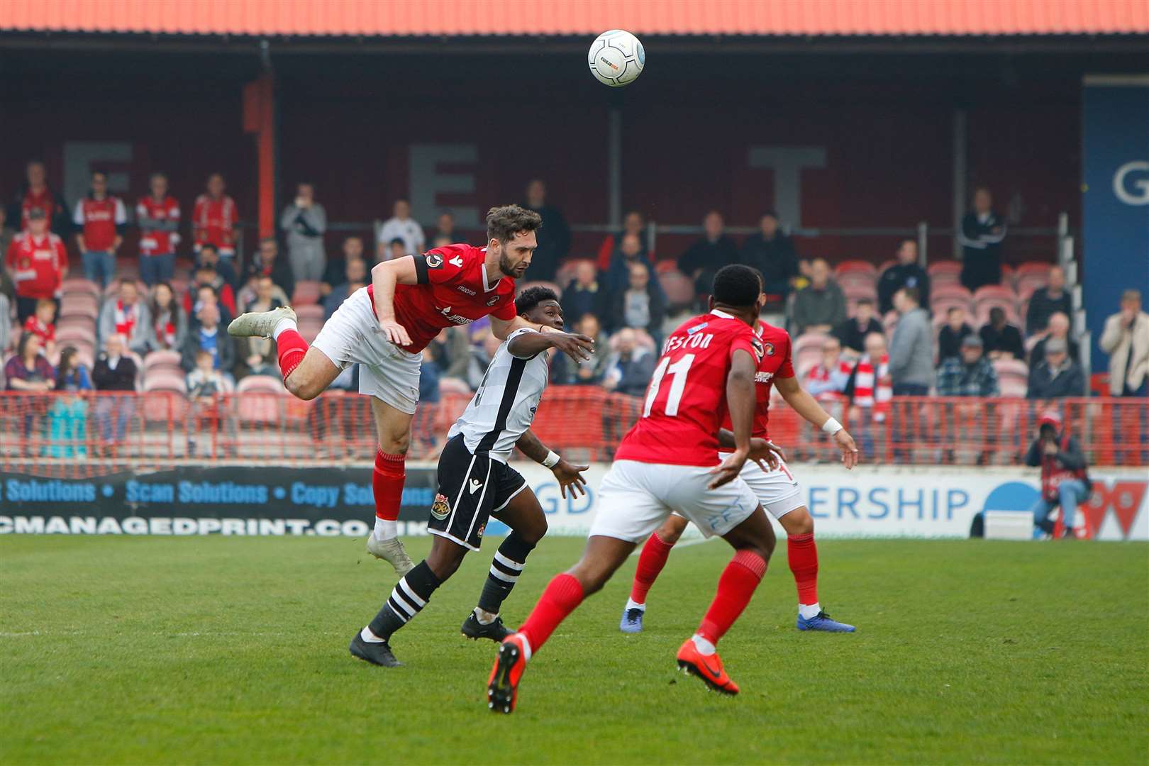 Dean Rance wins a header in midfield Picture: Andy Jones