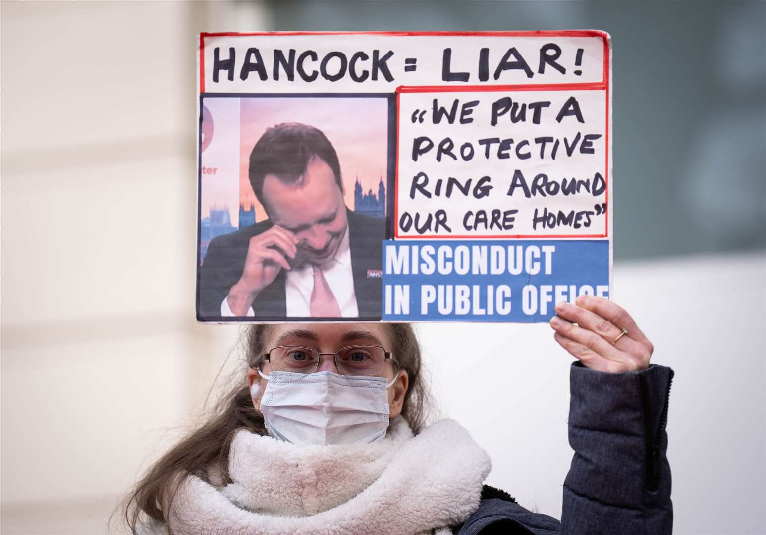 A person holds up a sign during the demonstration (James Manning/PA)