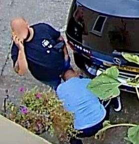 A man appears to interfere with the car. Photo: Lucy Tester